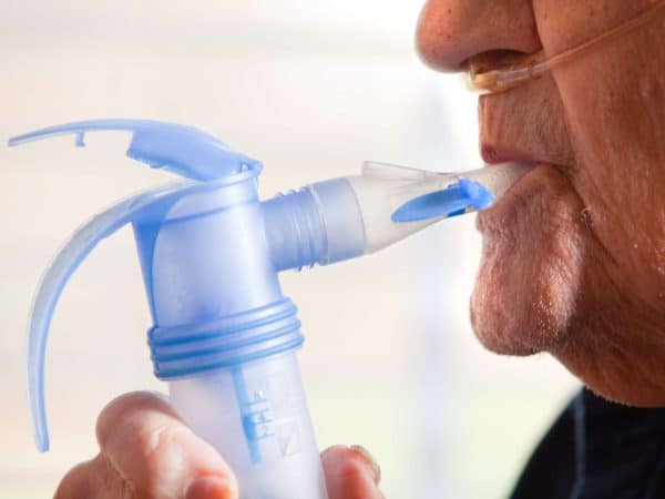 Close Up Of Elderly Man Using Nebulizer A close up of a 91 year old man using a nebulizer.