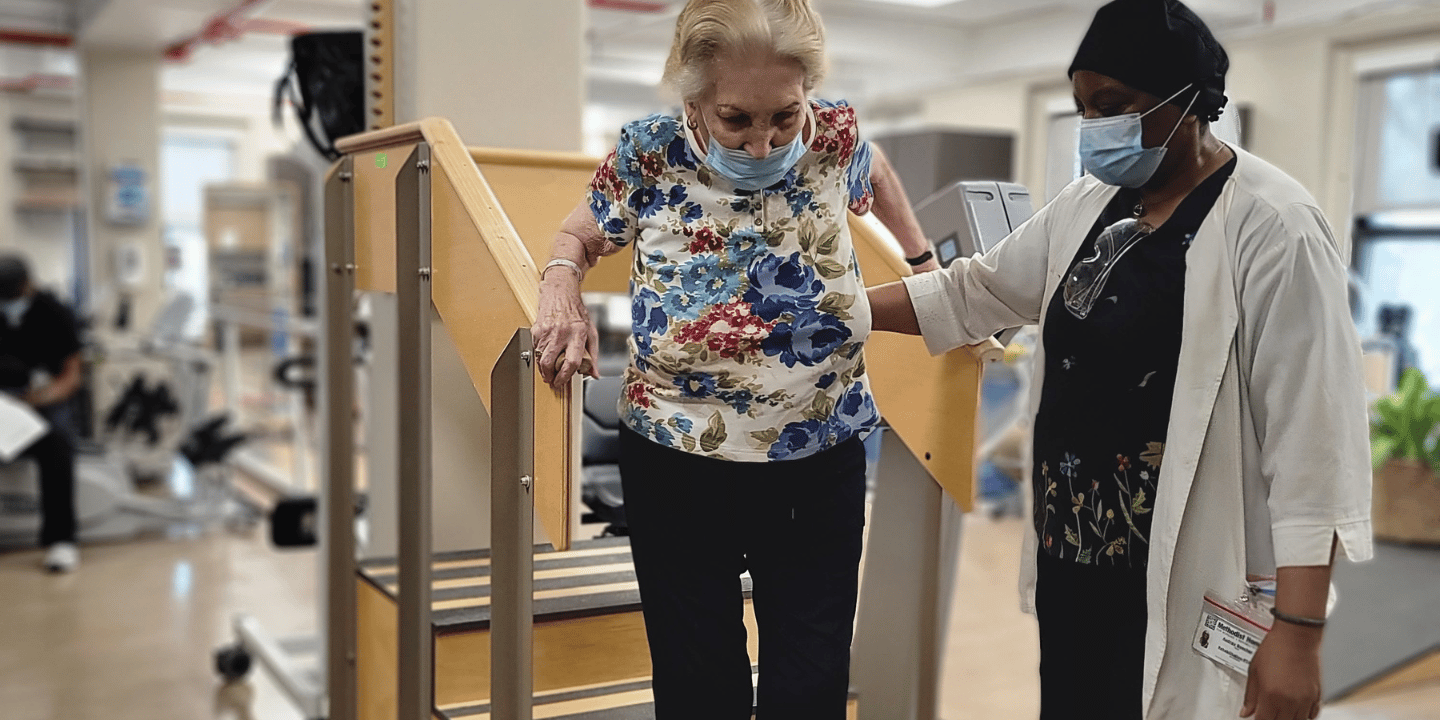 Woman walking down steps during physical therapy session