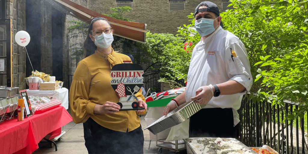 Dining staff grilling for residents during a summer party sponsored by donors of our non-profit organization.