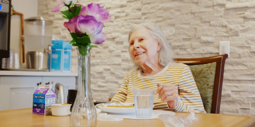 Smiling senior woman enjoying breakfast during a short term rehab stay at the Methodist Home