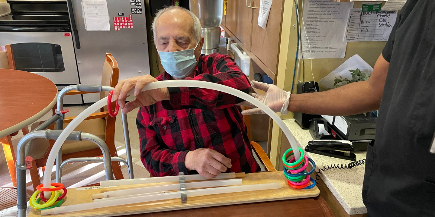 Photo of a short term rehab patient in an occupational therapy session as part of stroke recovery