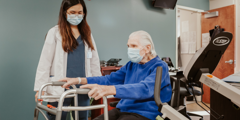 Photo of man with a walker during his physical therapy session with therapist
