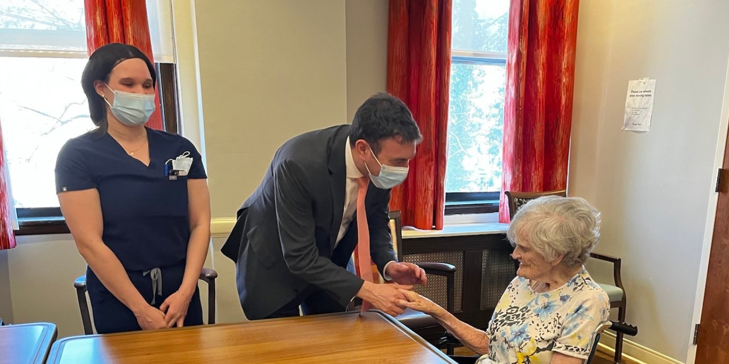 Featured blog p9ost image showing Councilman Eric Dinowitz with a Methodist Home resident, with staff person looking on