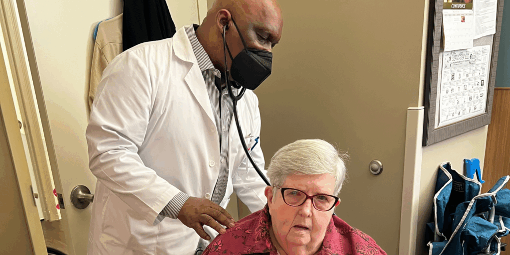 Photo of a short term rehab patient getting her lungs checked by a respiratory therapist in a skilled nursing facility.