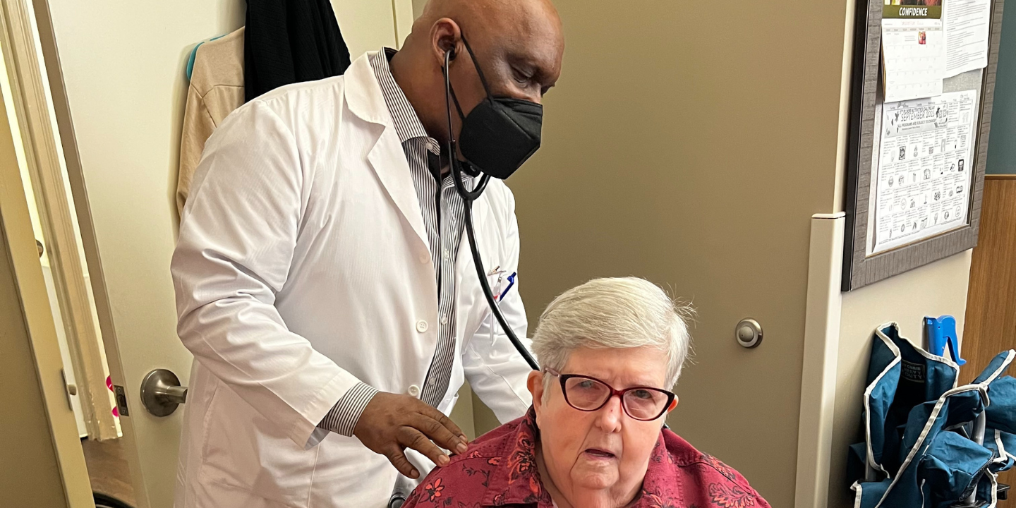 Photo of a short term rehab patient getting her lungs checked by a respiratory therapist in a skilled nursing facility.